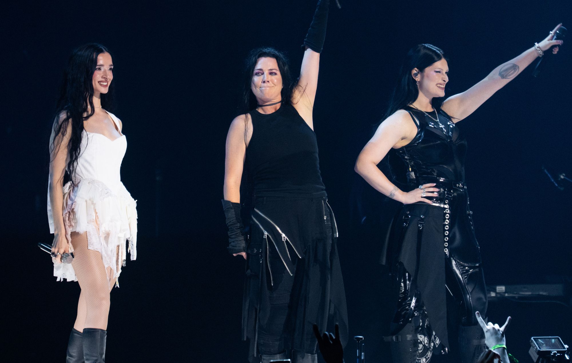 Amy Lee of Evanescence singing on stage under concert lights