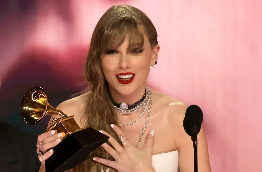Taylor Swift performing on stage in a glittering outfit under stage lights