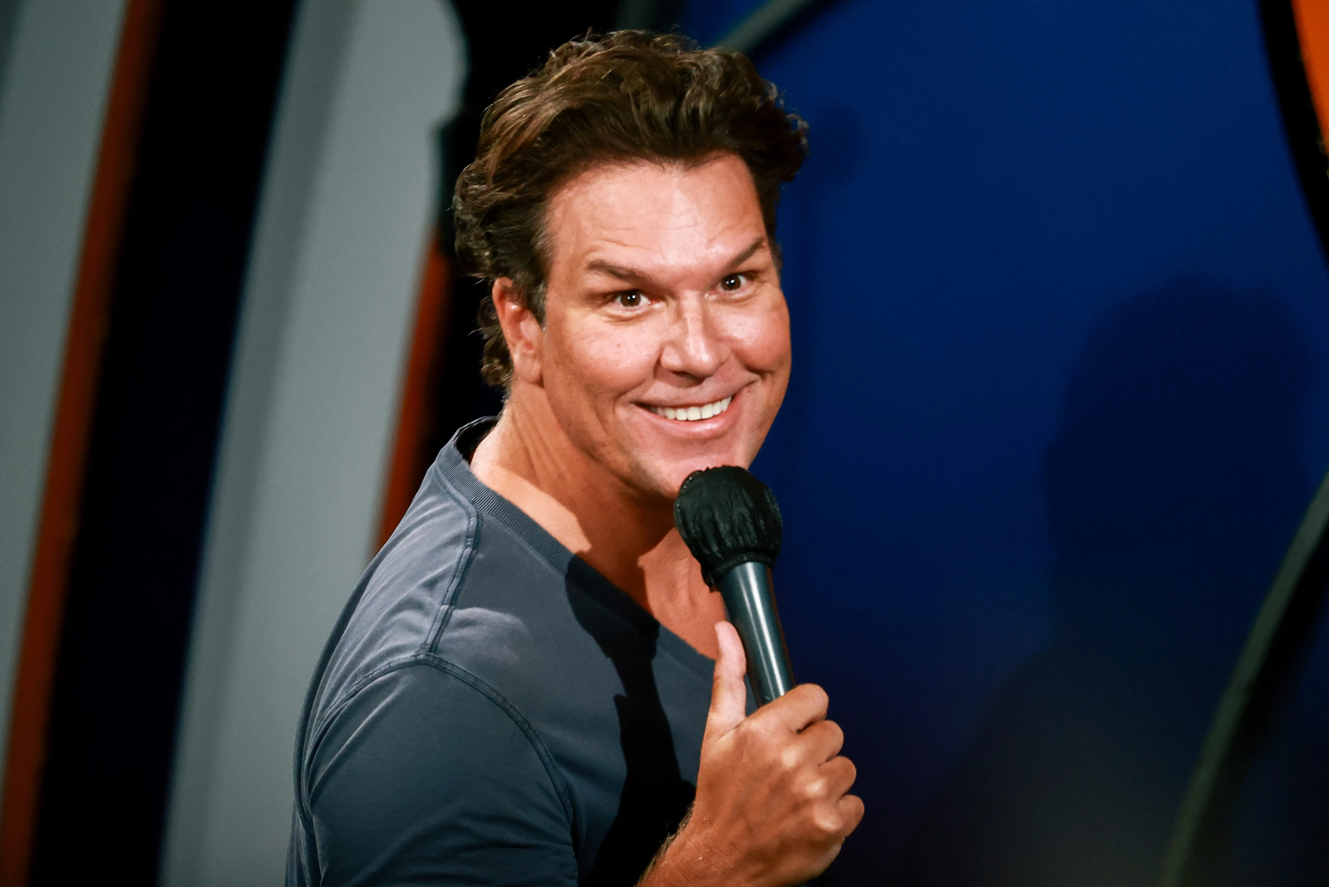 Comedian Dane Cook speaking on stage