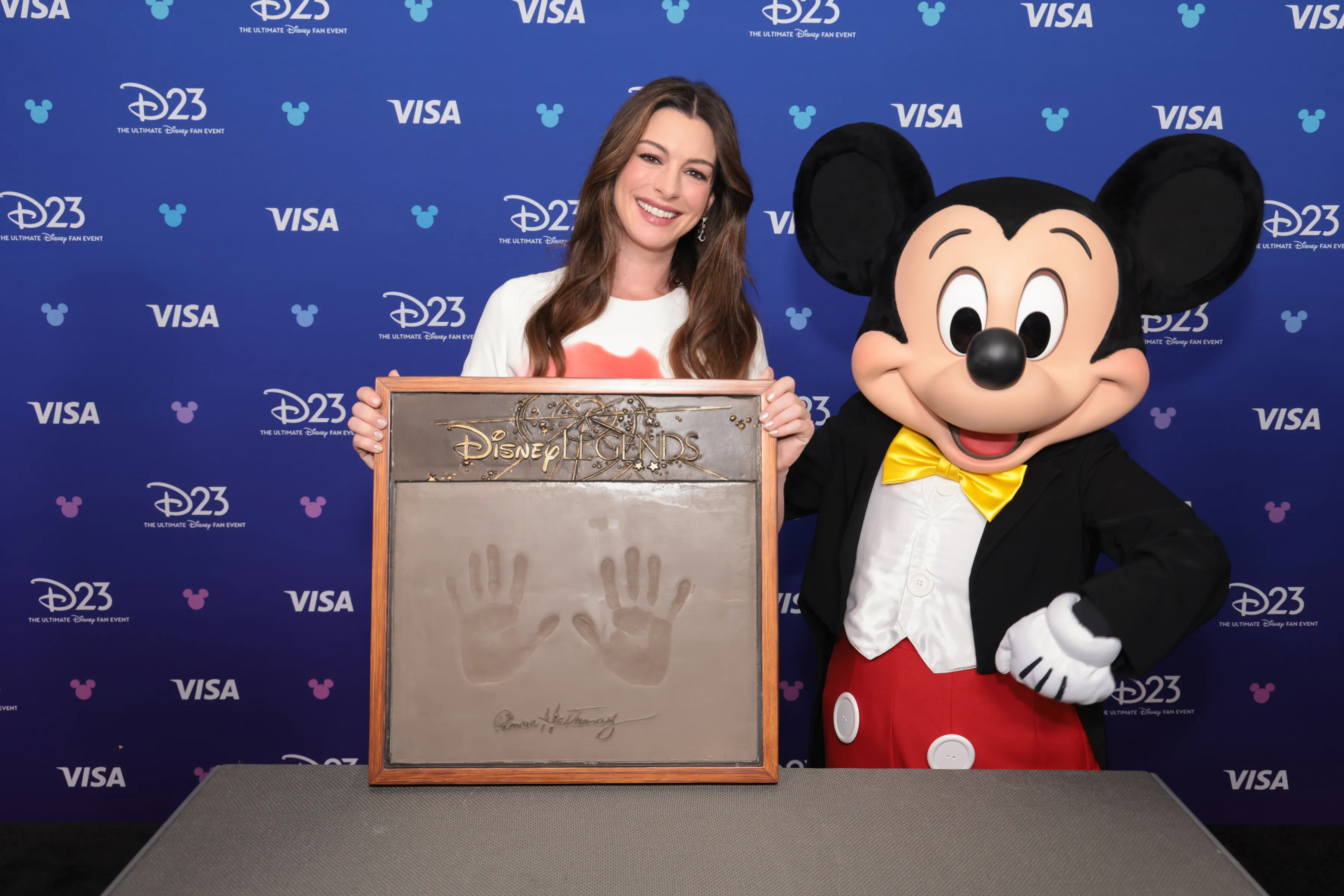Sunday, August 16, 2026. Anne Hathaway, Mickey Mouse at the 2026 Disney Legends Awards Ceremony as part of D23: The Ultimate Disney Fan Event presented by Visa in Anaheim, CA. (The Walt Disney Company/Image Group LA)
