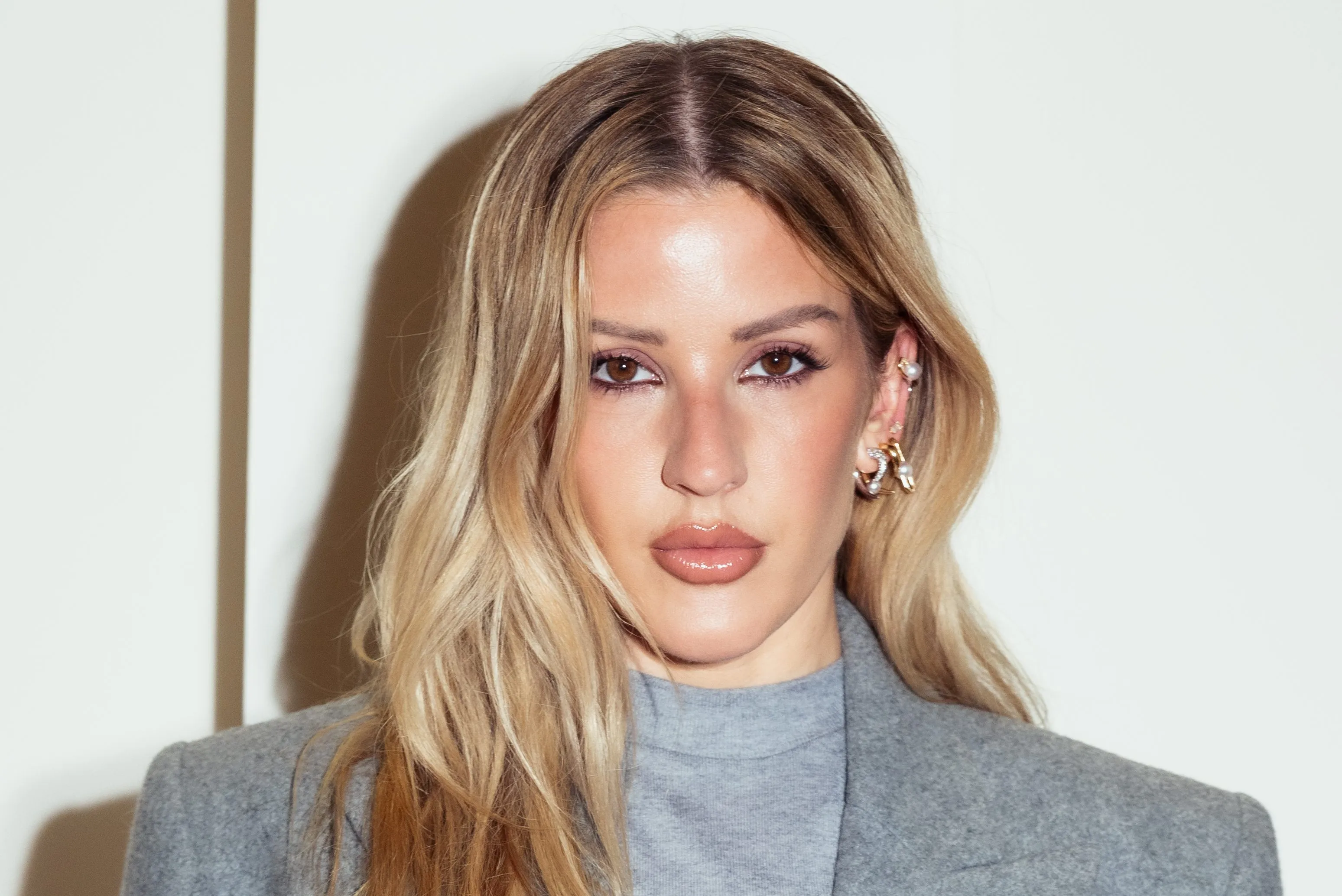 Ellie Goulding posing on a red carpet at a music industry event