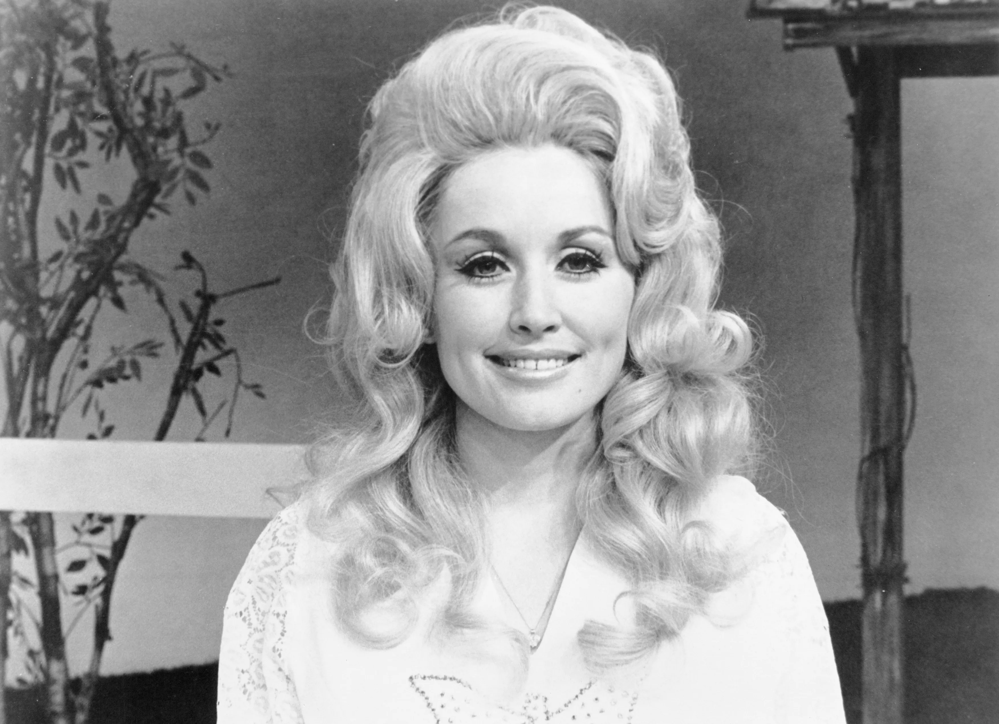 Dolly Parton performing live on stage with a guitar