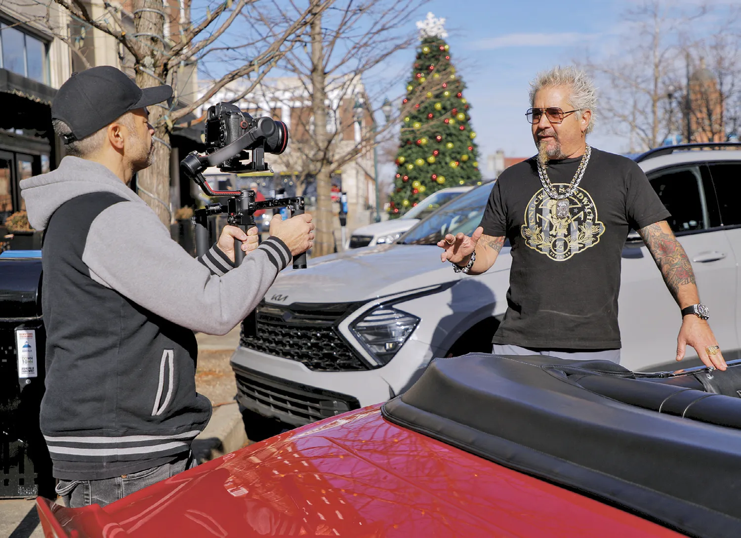 Guy Fieri speaking at a public culinary event