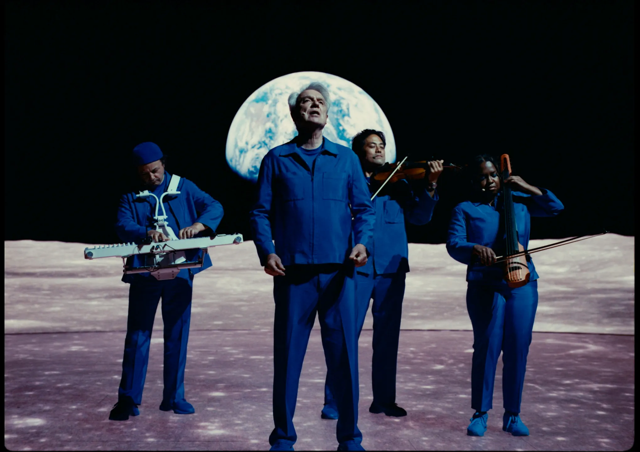 David Byrne performing live on stage during a concert tour