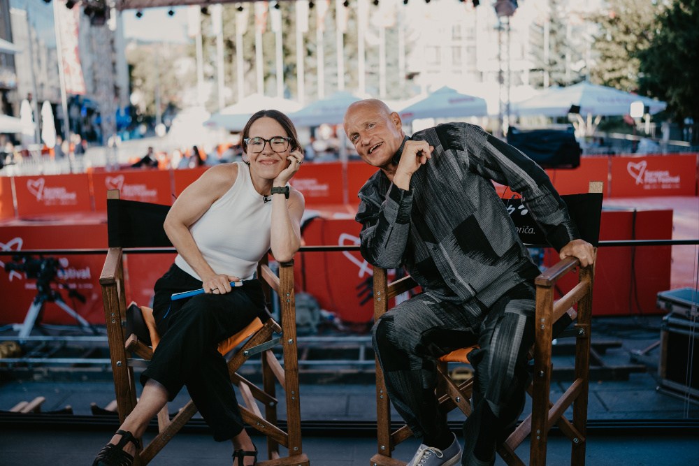 Woody Harrelson smiling at a public event.