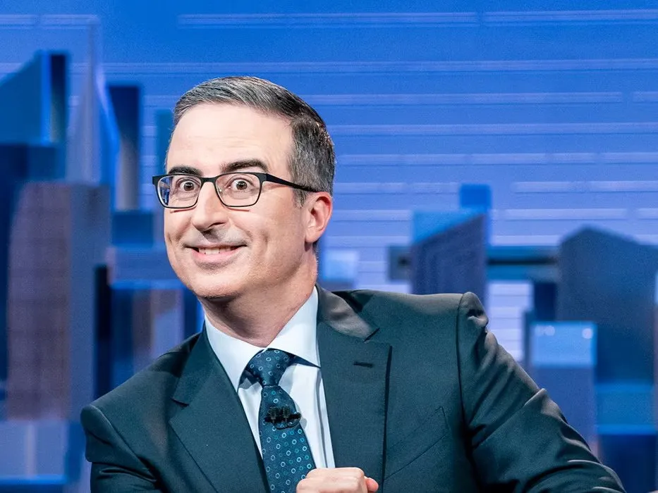 John Oliver host of Last Week Tonight speaking at his desk