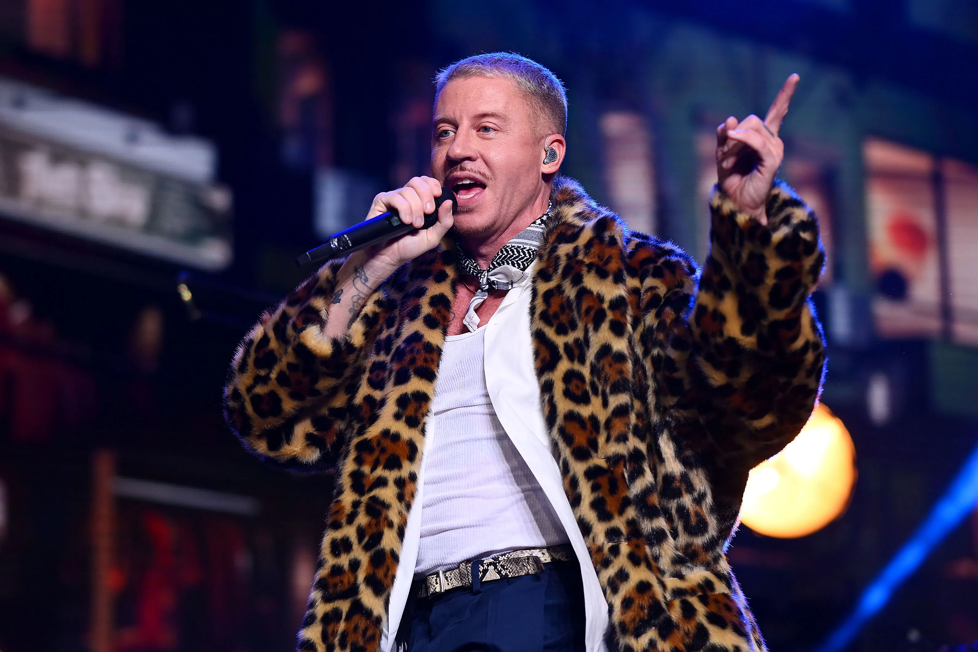 Macklemore performing on stage during a concert tour