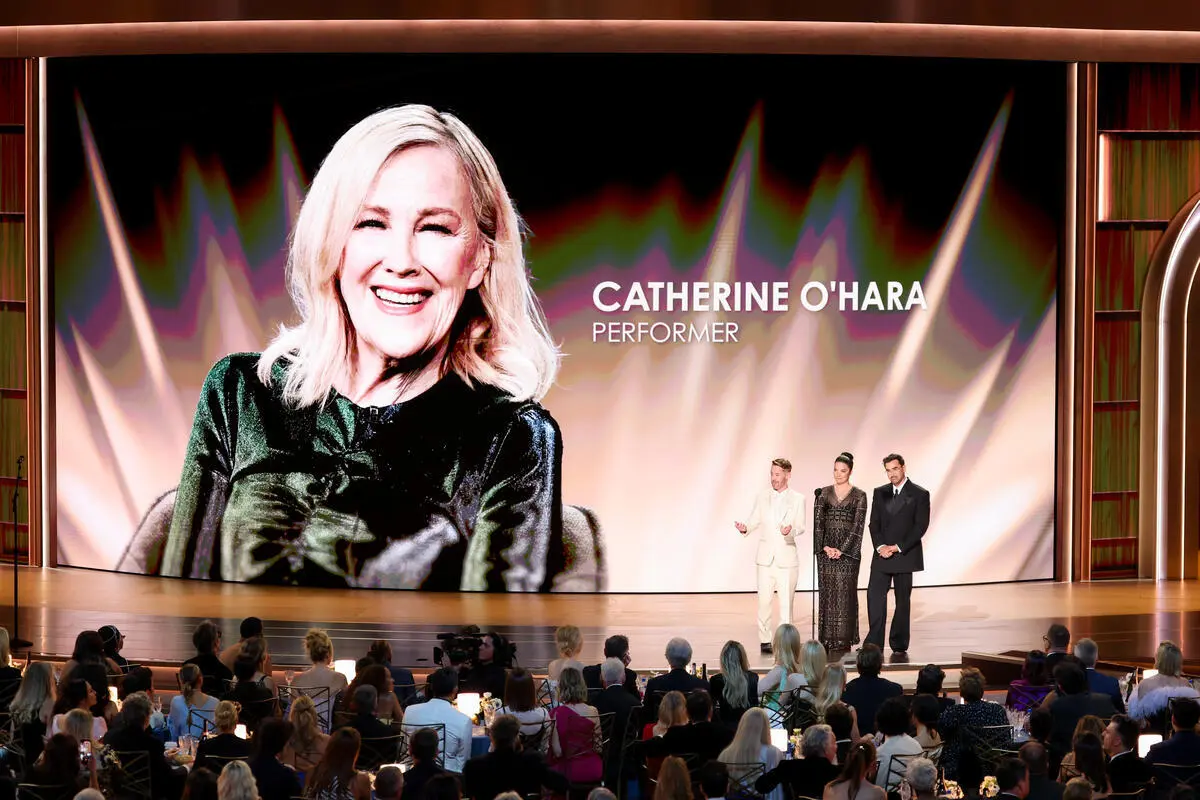 Macaulay Culkin, Dan Levy, and Annie Murphy on stage at the Emmy Awards