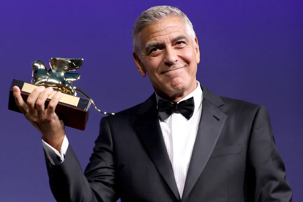 George Clooney speaking on stage at the Venice Film Festival masterclass.