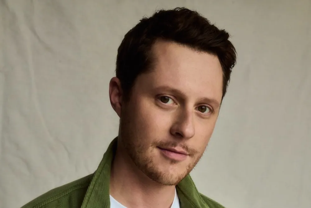 Noah Reid posing at a red carpet event