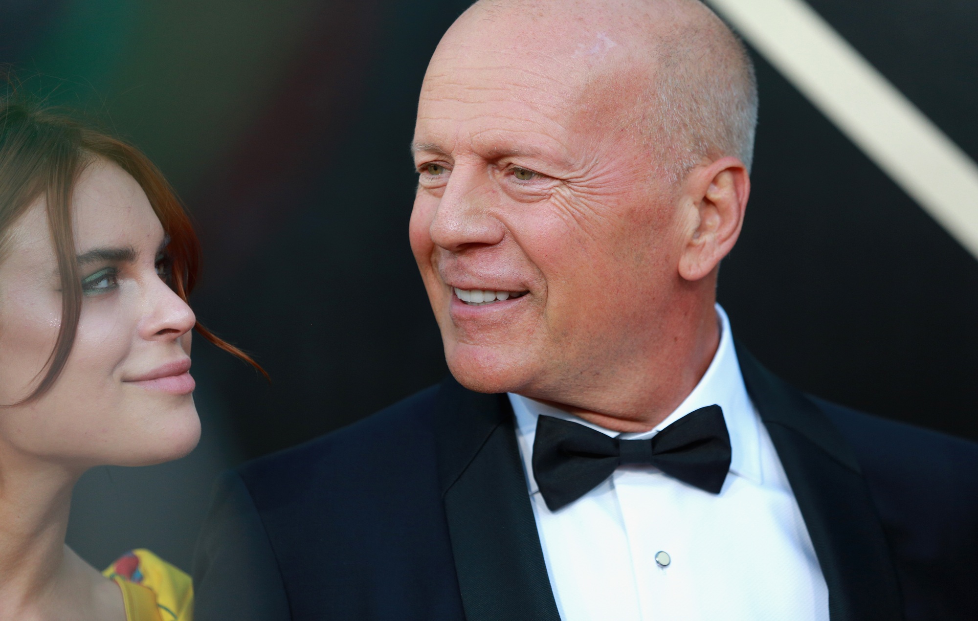 Bruce Willis smiling with daughter Tallulah Willis and Justin Acee