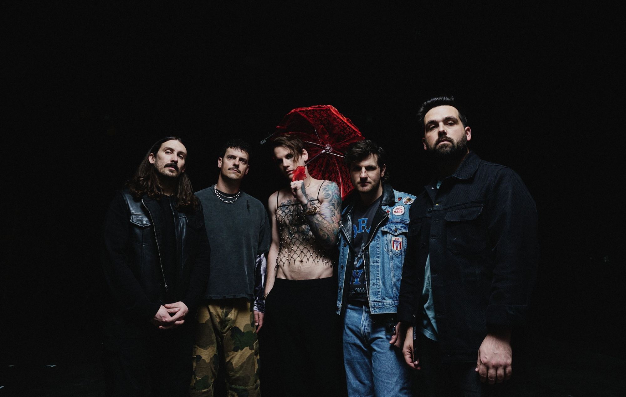 Caleb Shomo performing on stage with Beartooth