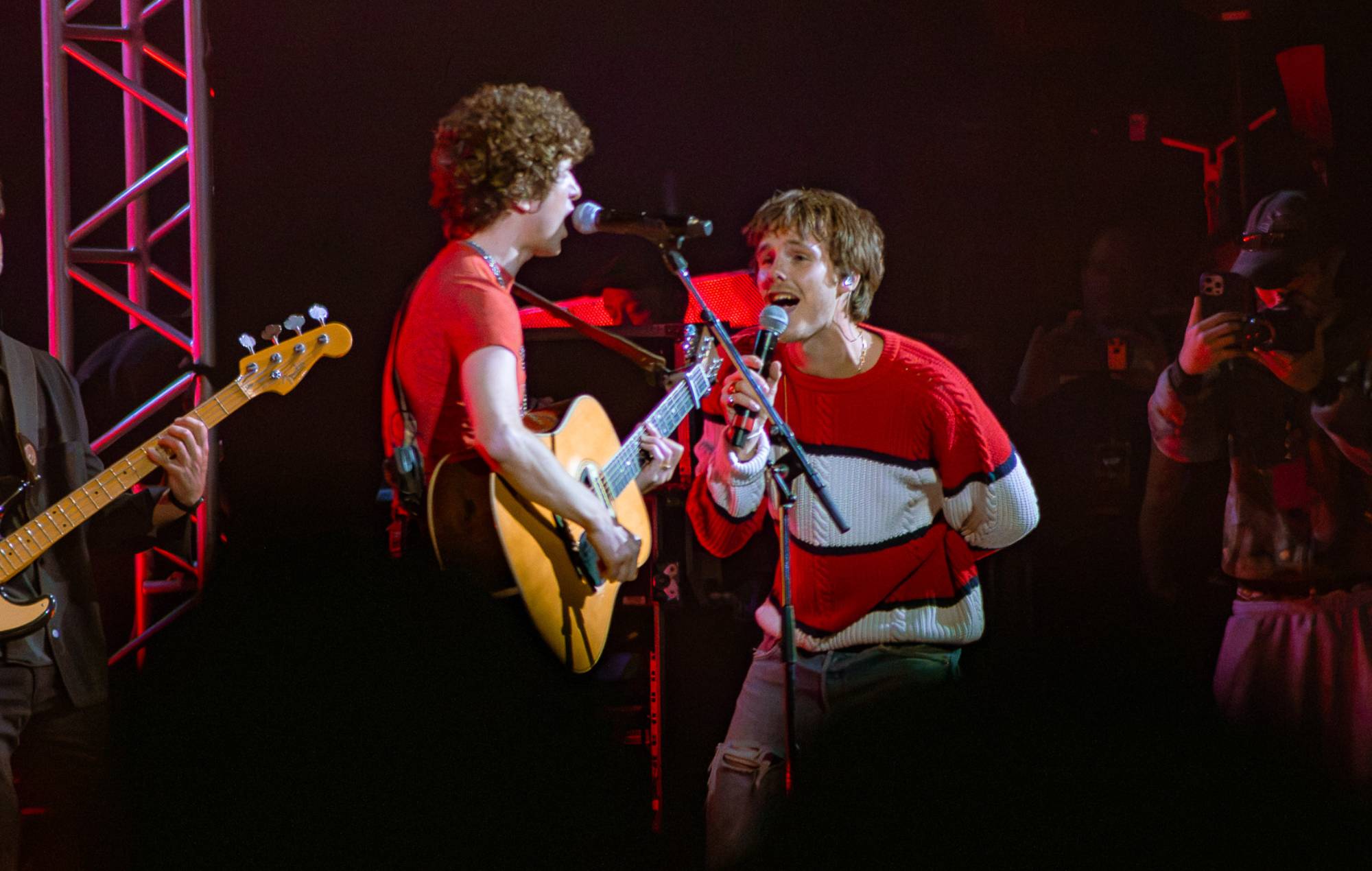 Cruz Beckham playing guitar on stage during a concert