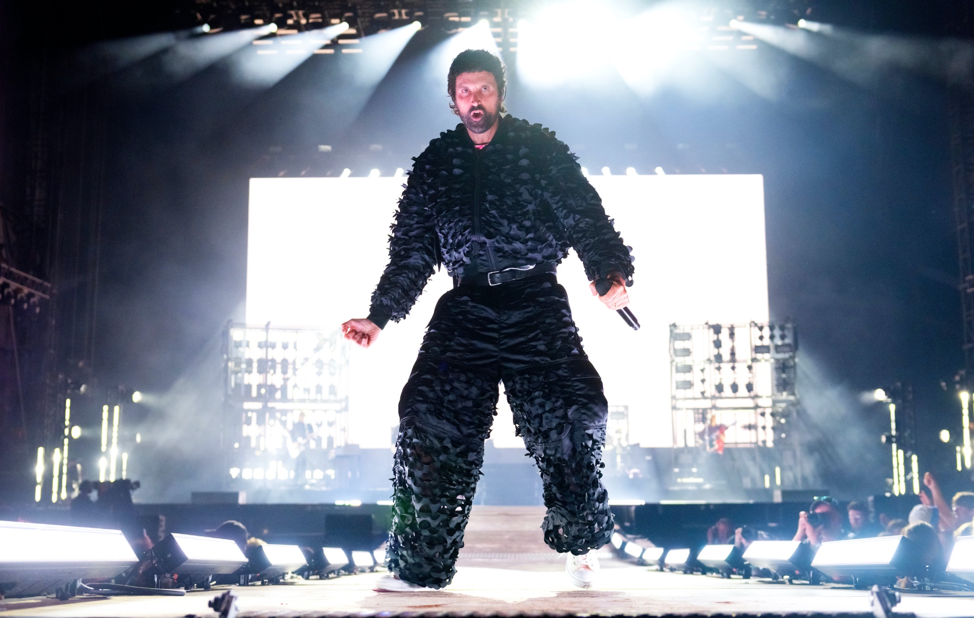 Kasabian frontman Serge Pizzorno performing live on stage at Leeds Festival