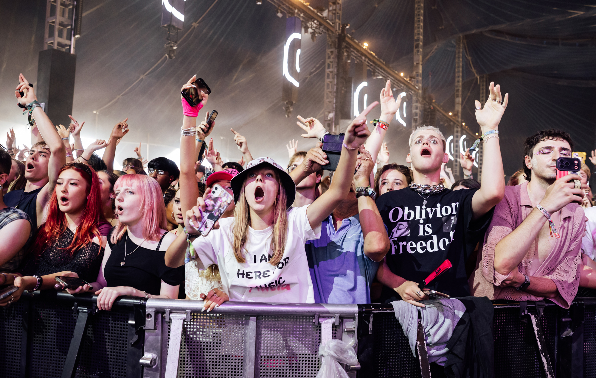 Crowds illuminated by lights at a bank holiday music festival