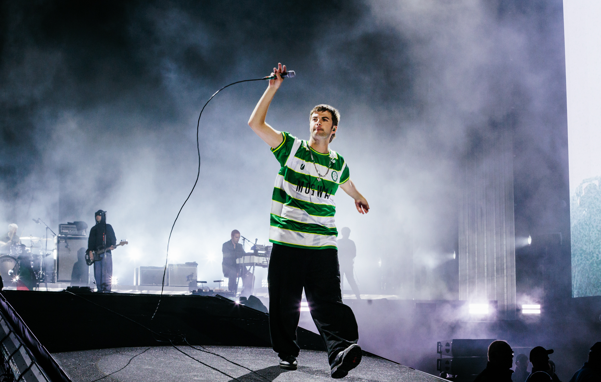 Grian Chatten performing on stage at Reading Festival
