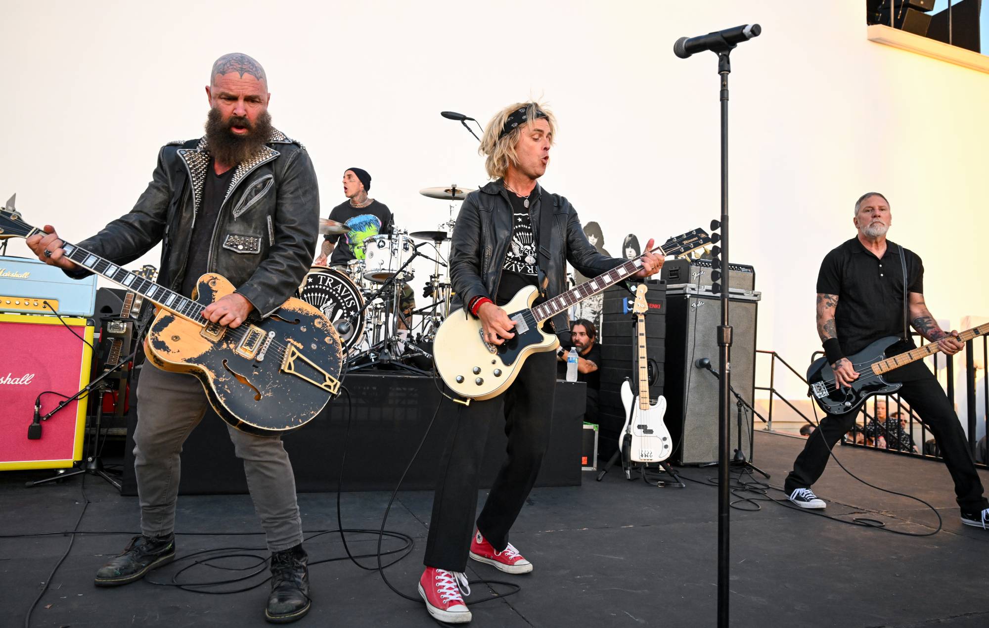 Billie Joe Armstrong and Travis Barker onstage performing during a punk tribute concert