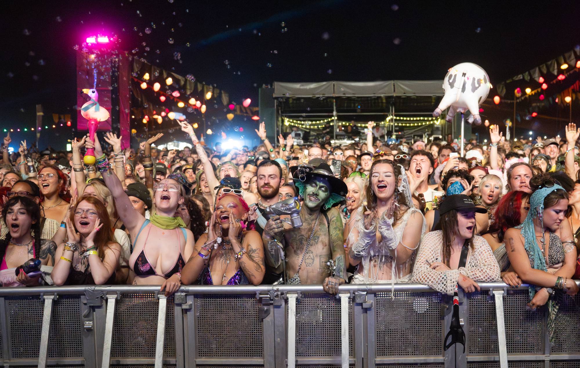 Music festival campers at Boomtown looking at their smartphones during a government emergency alert