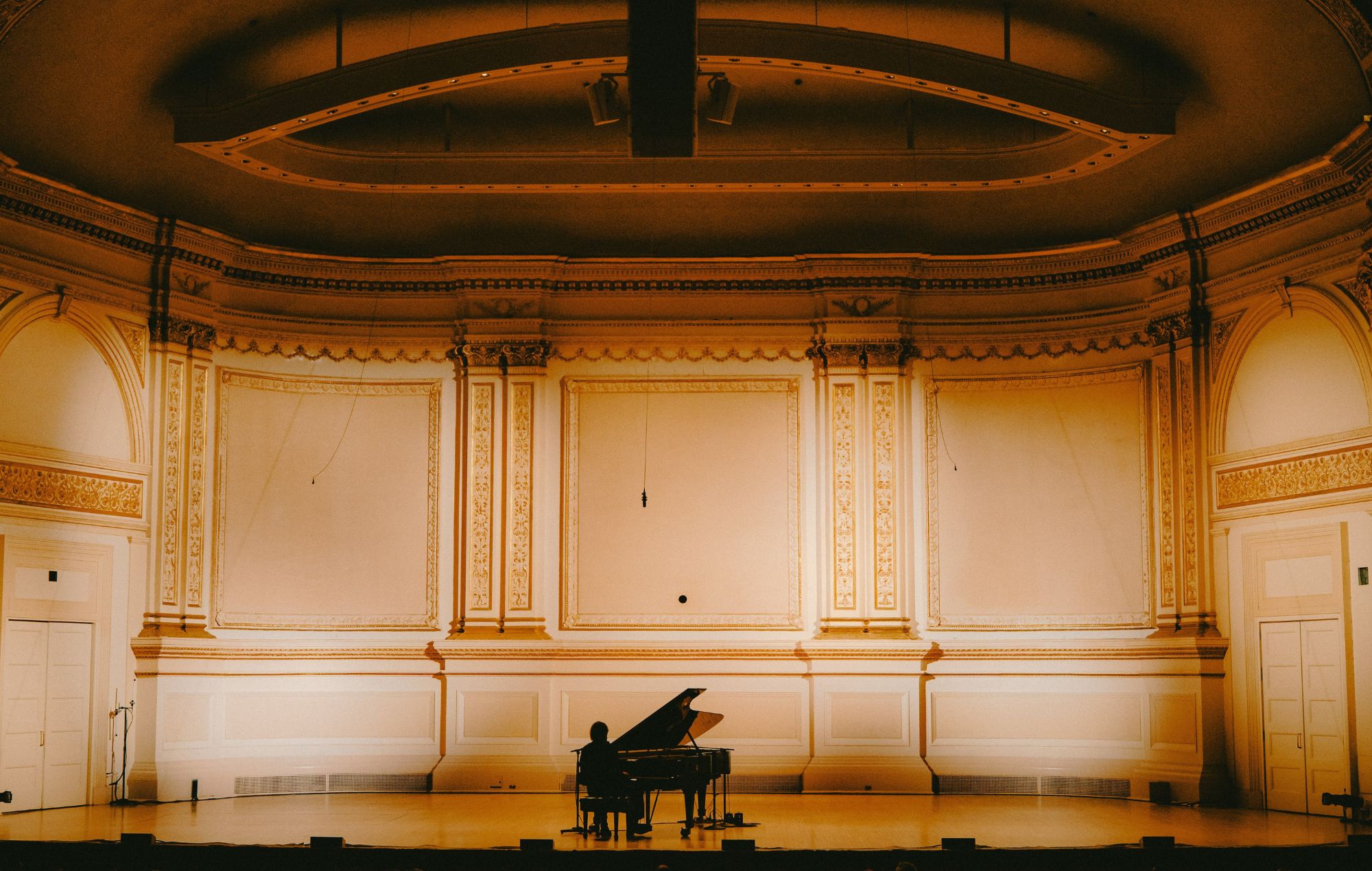 Cameron Winter performing live on stage at piano