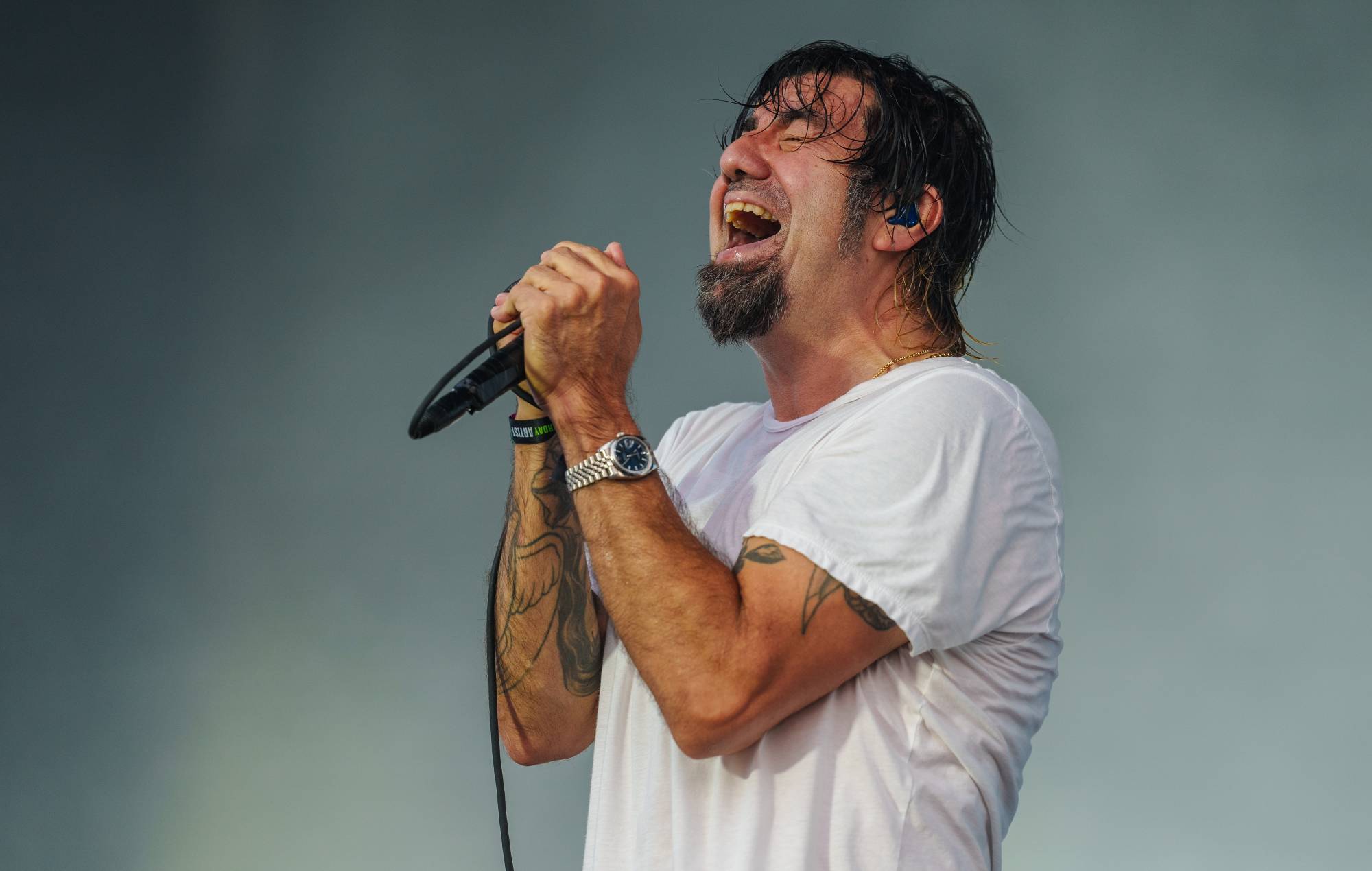 Chino Moreno performing on stage with Deftones