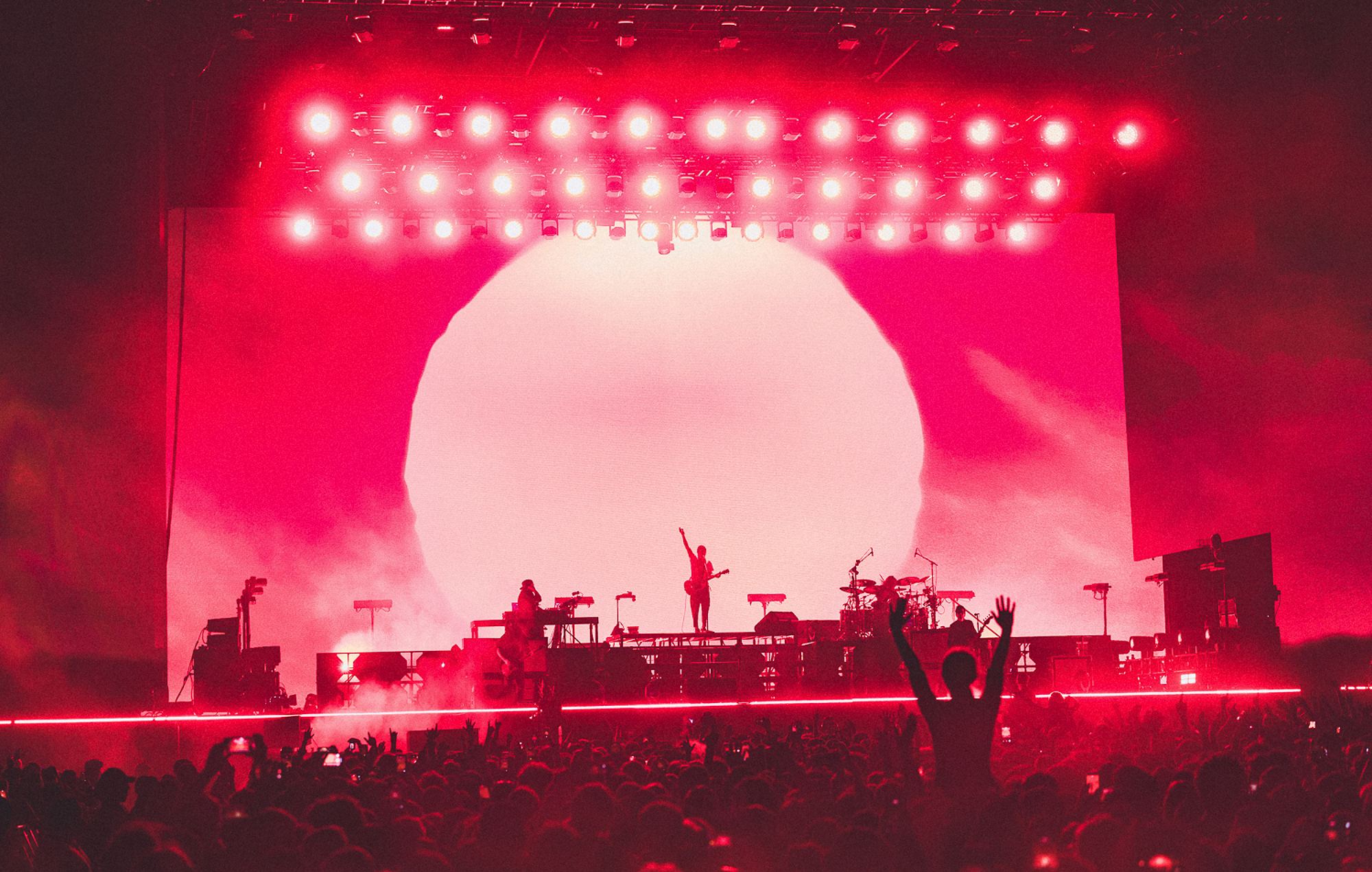 Deftones performing live on stage at a major outdoor festival concert
