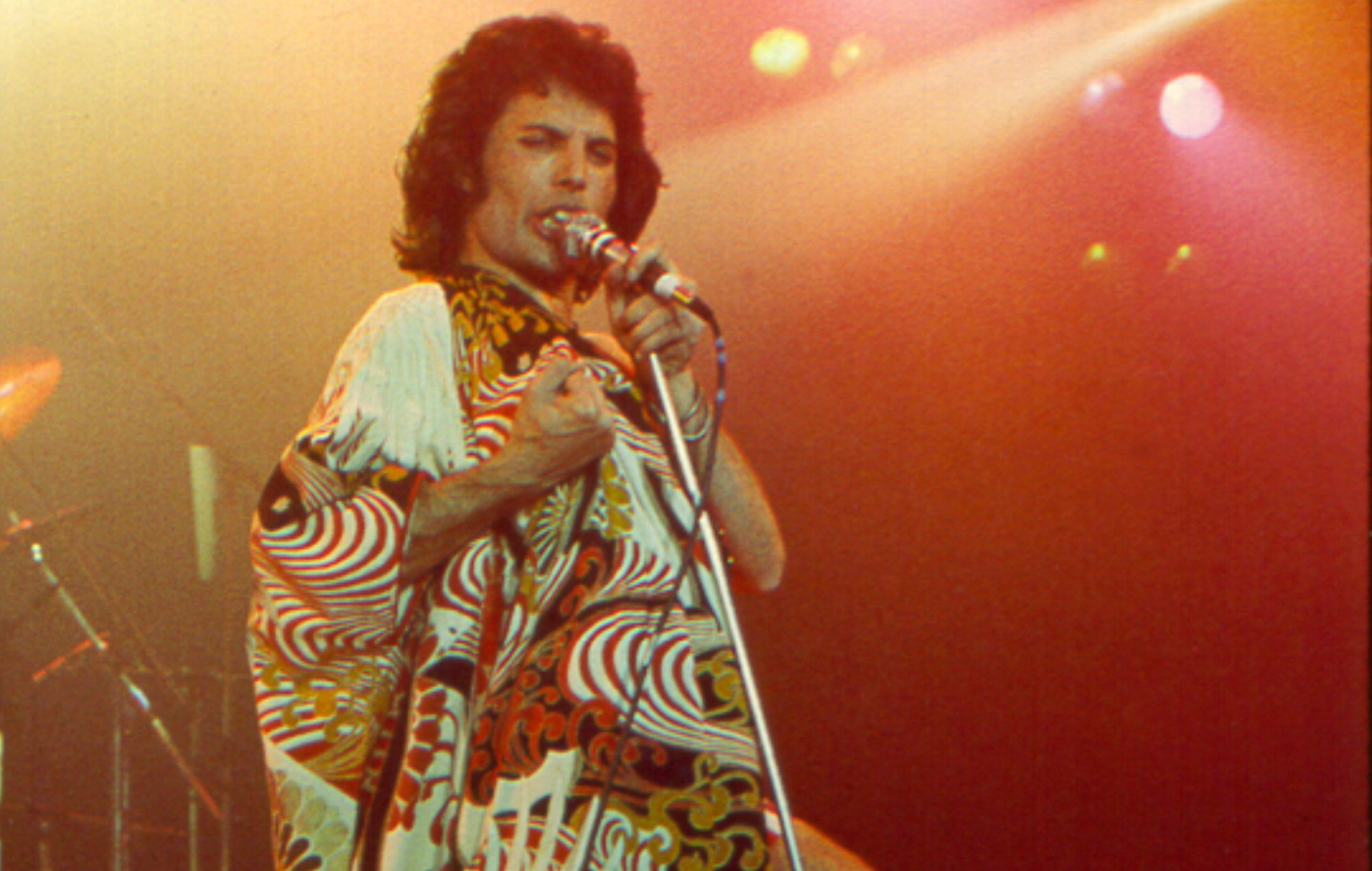 Early Queen bassist Barry Mitchell performing on stage in the 1970s