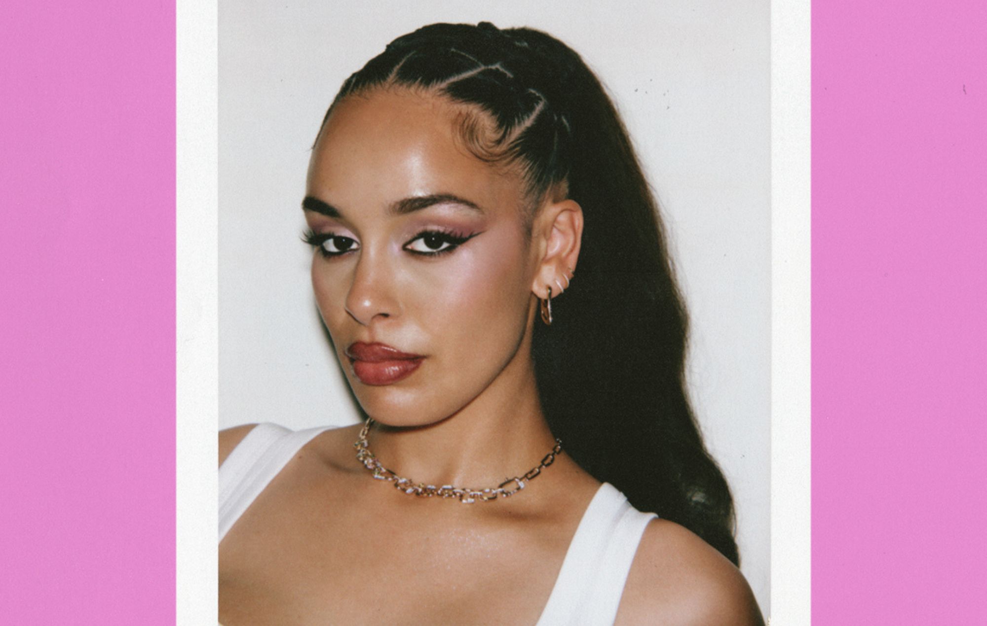 R&B singer Jorja Smith performing on stage under red lighting