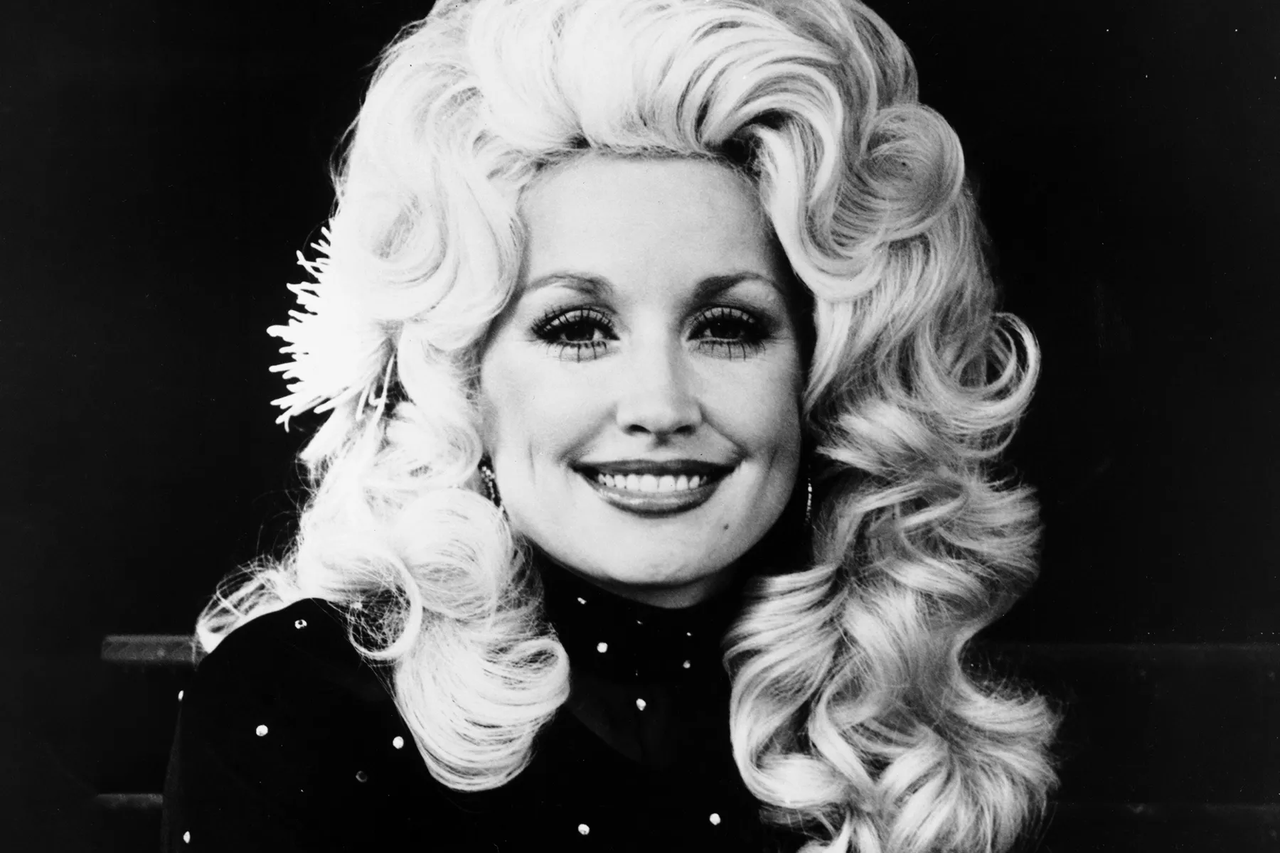 Country music icon Dolly Parton posing on stage at a concert performance