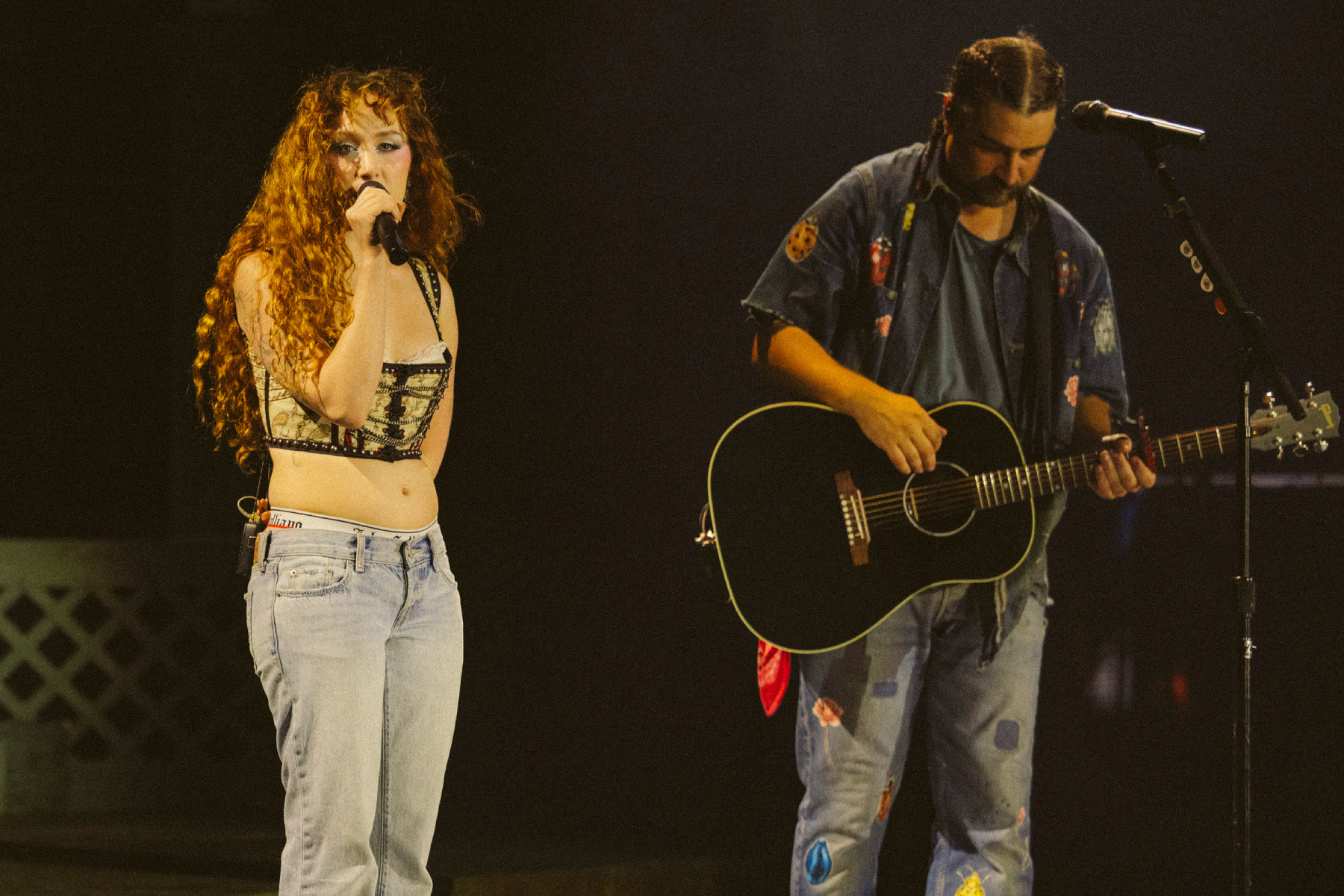 Noah Kahan performing live on stage during a concert tour stop