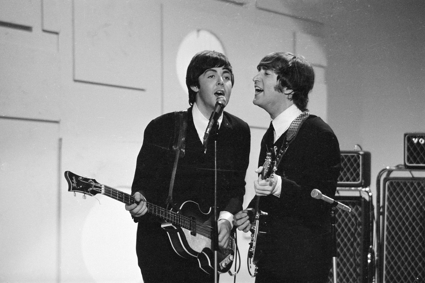Paul McCartney and John Lennon laughing during a Beatles recording session