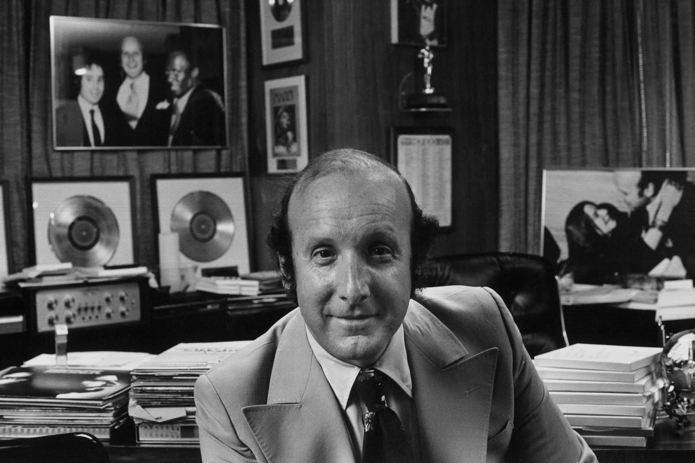Music executive Clive Davis attending an industry event in a formal suit