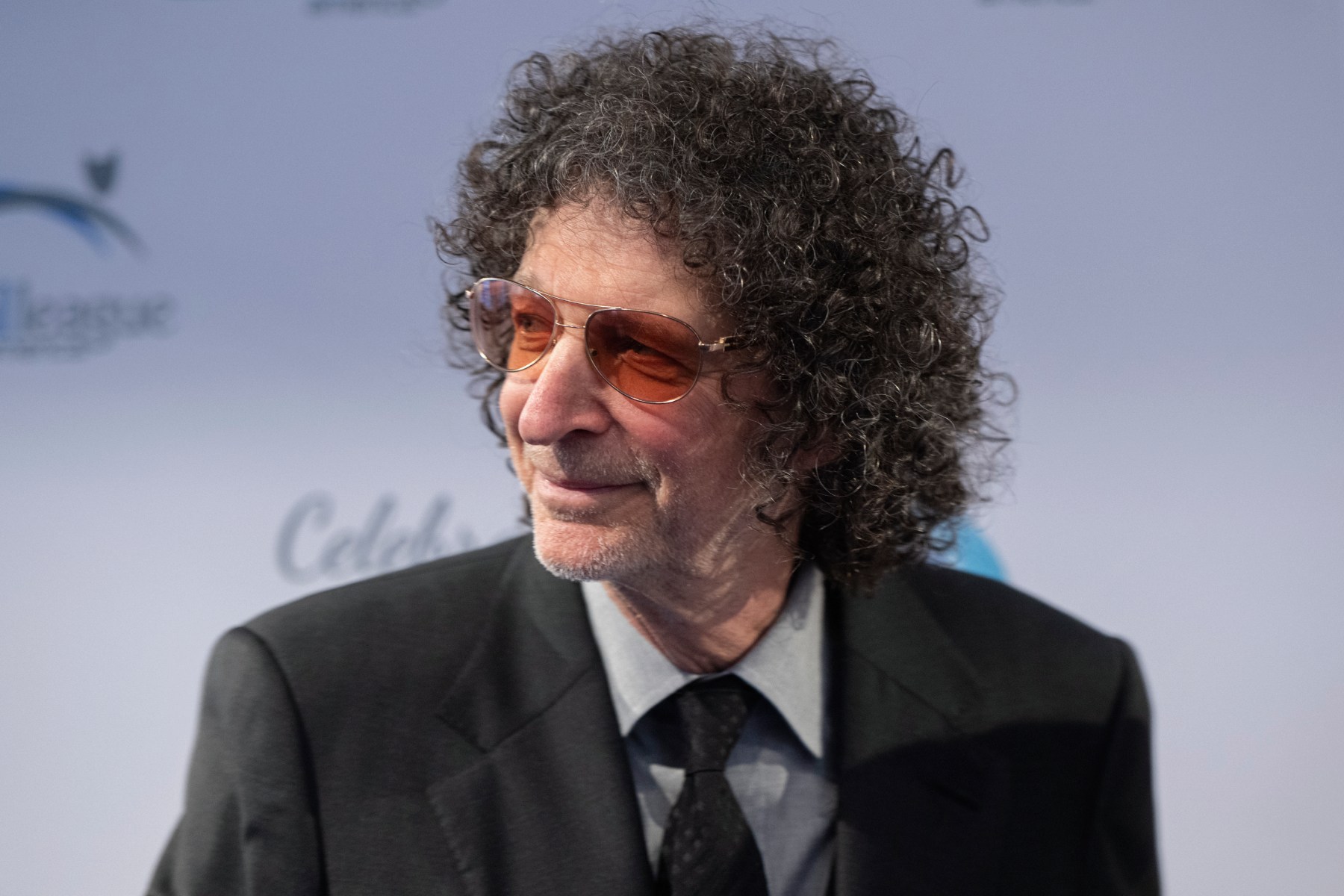 Howard Stern speaking into a microphone during a broadcast