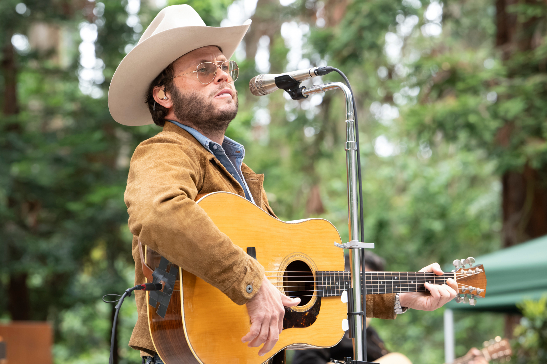 Charley Crockett performing on stage during a concert