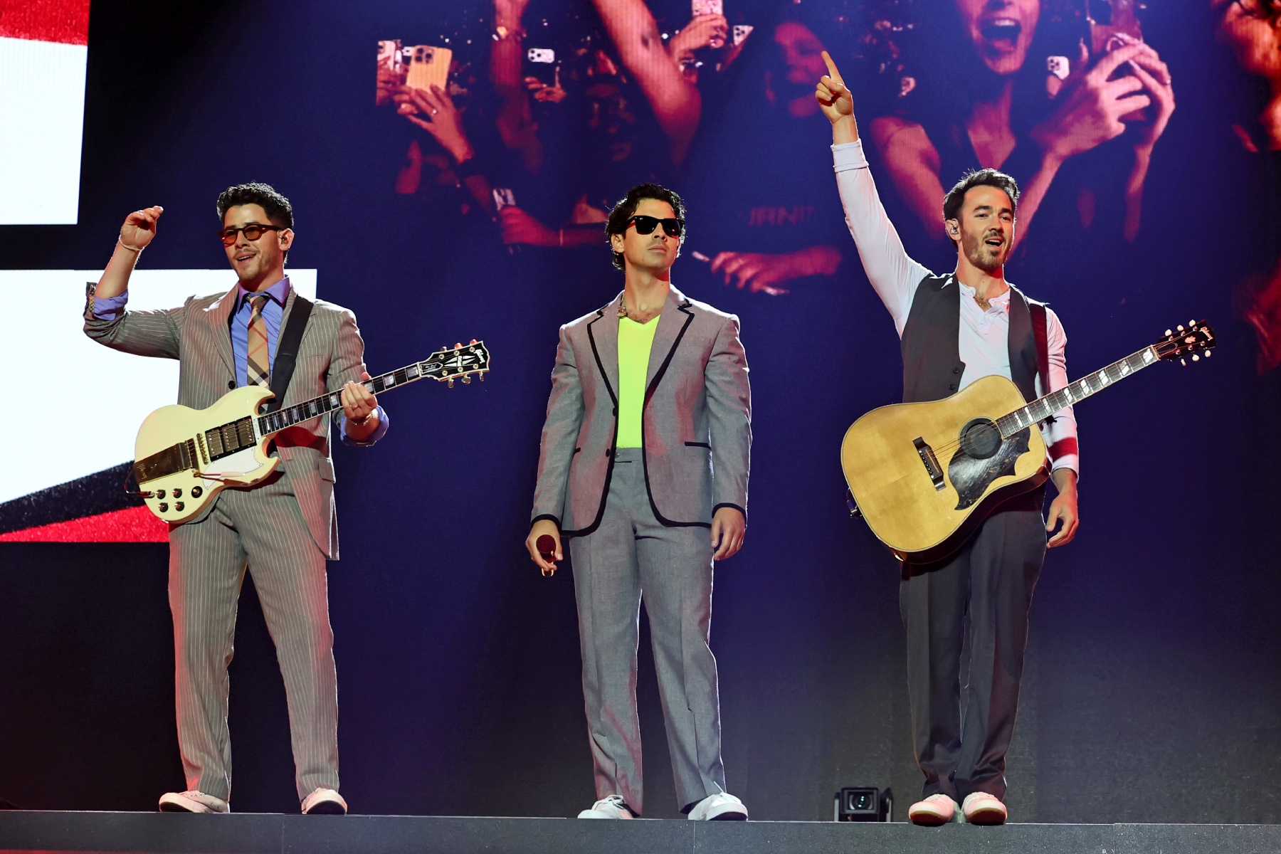The Jonas Brothers performing live on stage during their concert tour