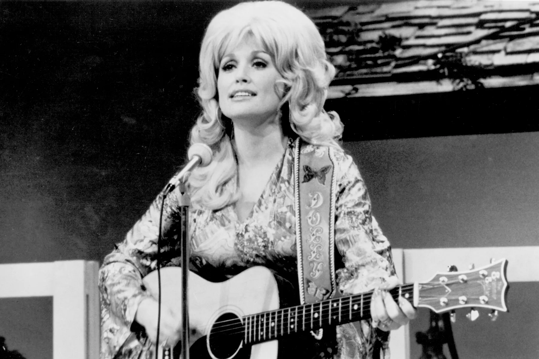 Dolly Parton smiling on stage during a public appearance