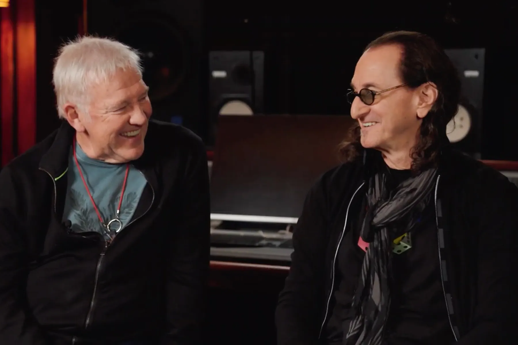 Geddy Lee and Alex Lifeson of Rush speaking during a music cover story interview.