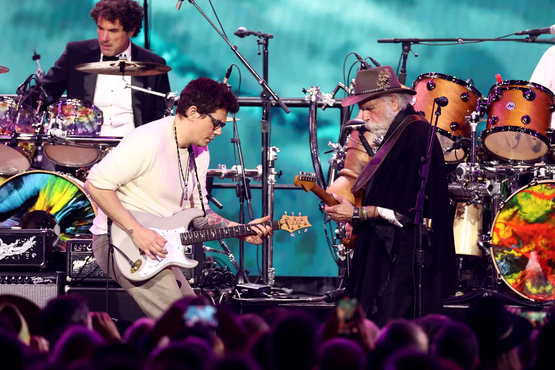John Mayer performing live with a guitar on stage