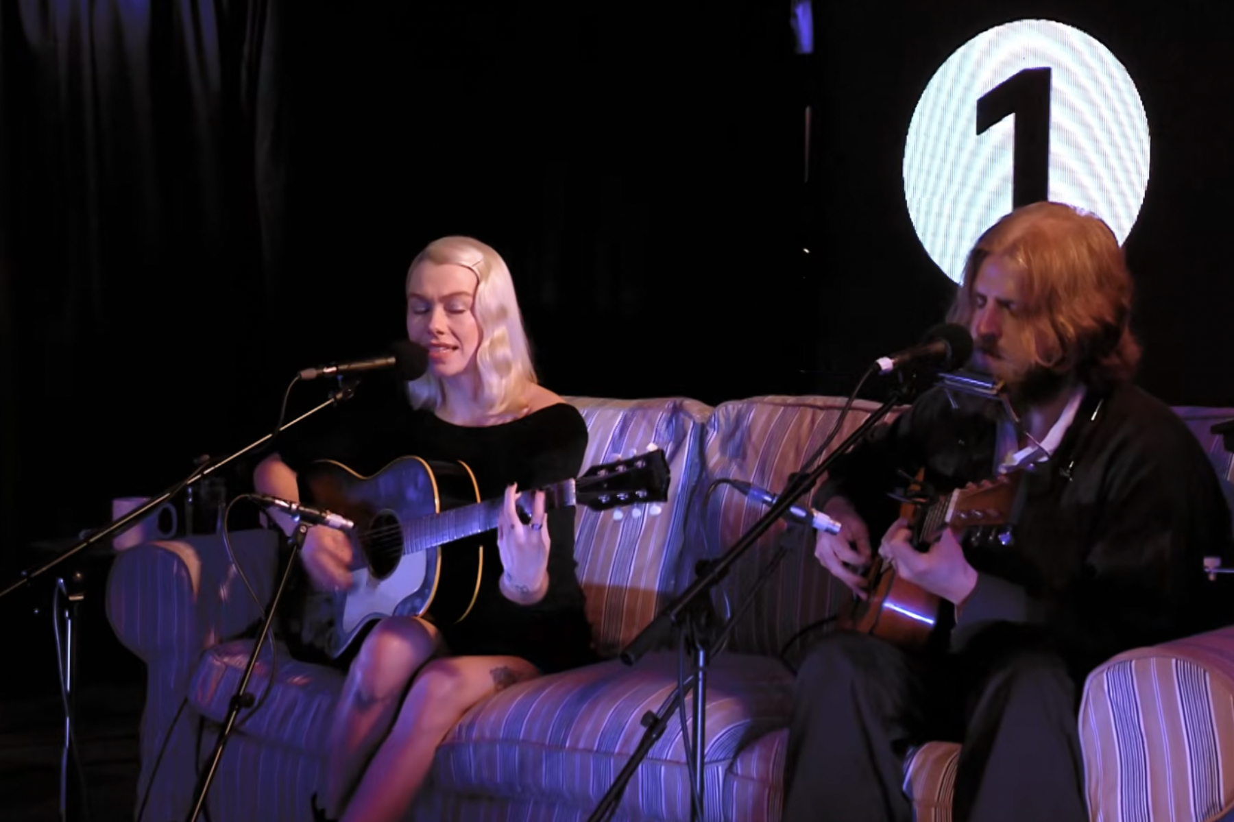 Phoebe Bridgers performing live in studio with guitar