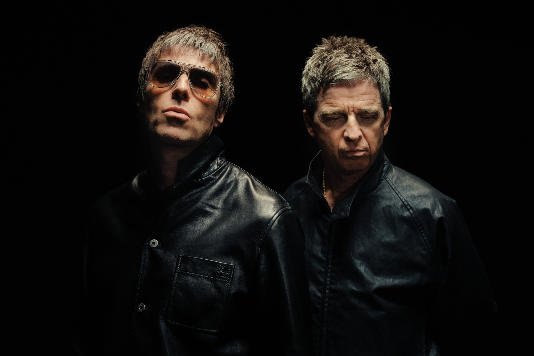Oasis performing live on stage during their global reunion tour