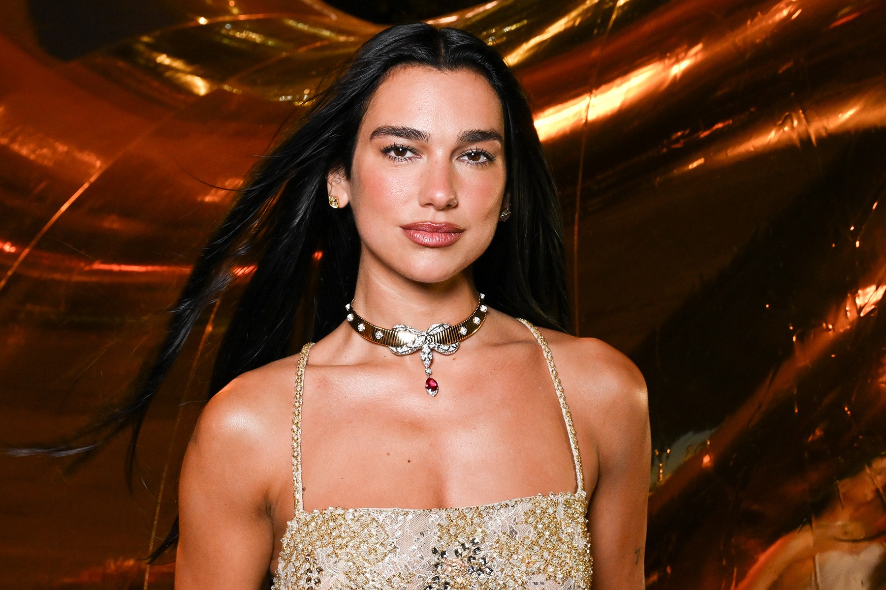 Dua Lipa posing at a high-profile entertainment event