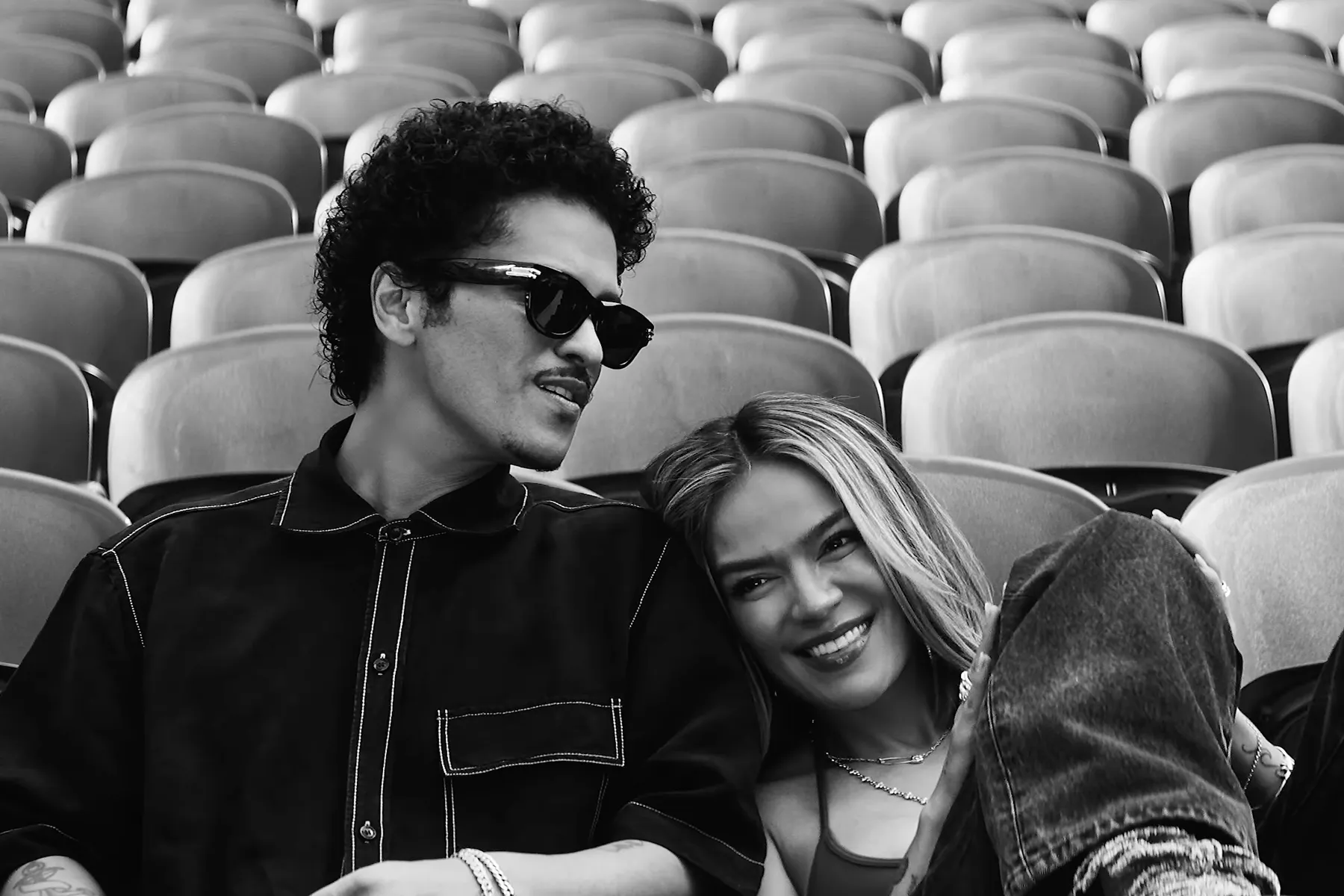 Karol G and Bruno Mars performing live onstage together at a stadium concert