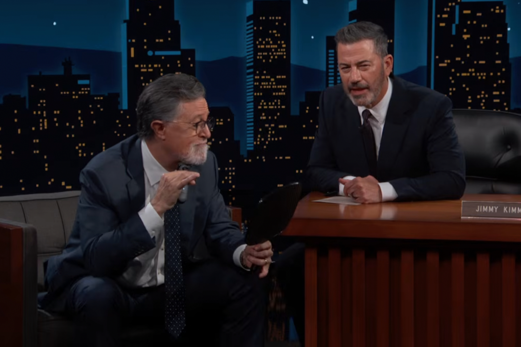 Stephen Colbert sitting on the Jimmy Kimmel Live couch before shaving off his beard