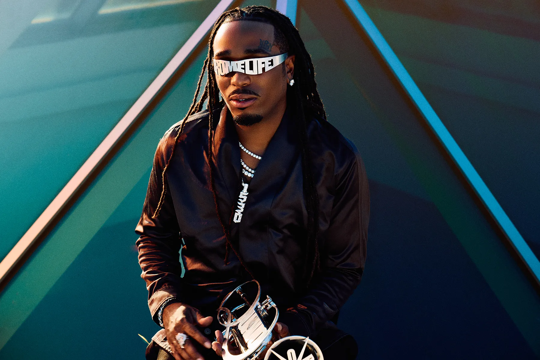 Quavo performing on stage with a microphone