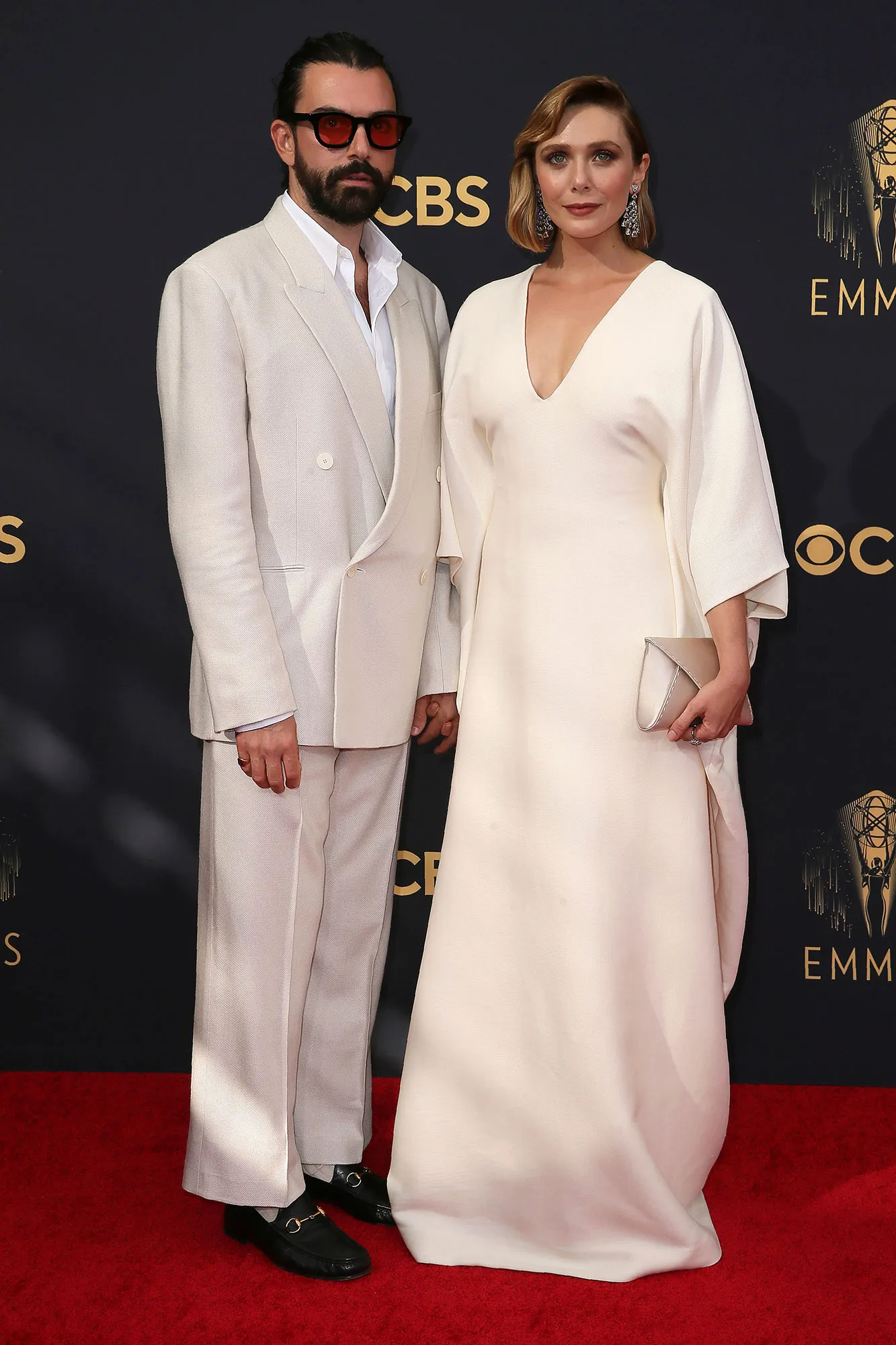 Elizabeth Olsen and Robbie Arnett posing at an event together