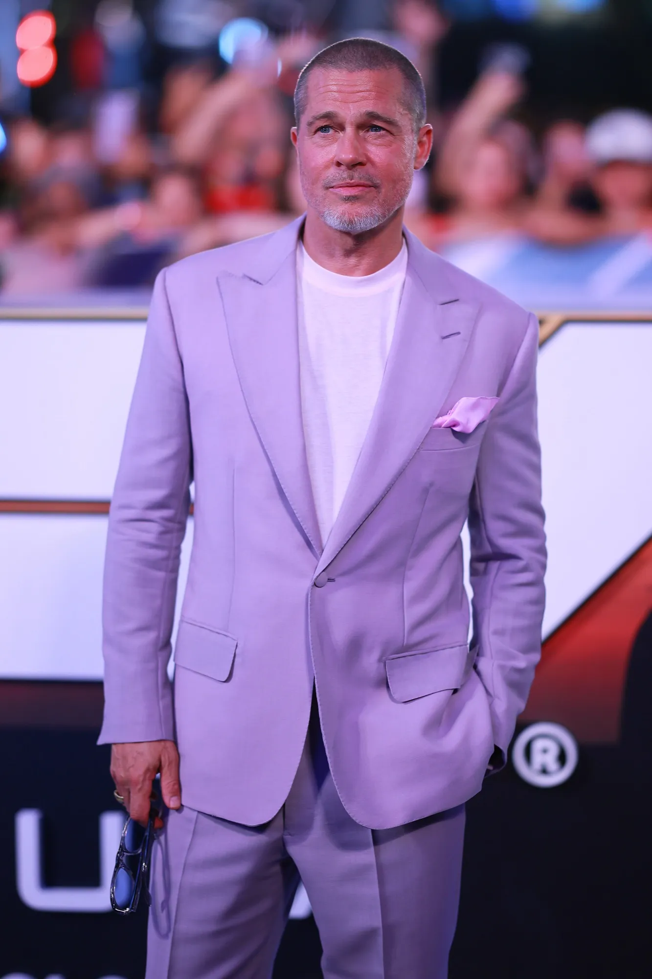 Brad Pitt posing on a red carpet in a tuxedo
