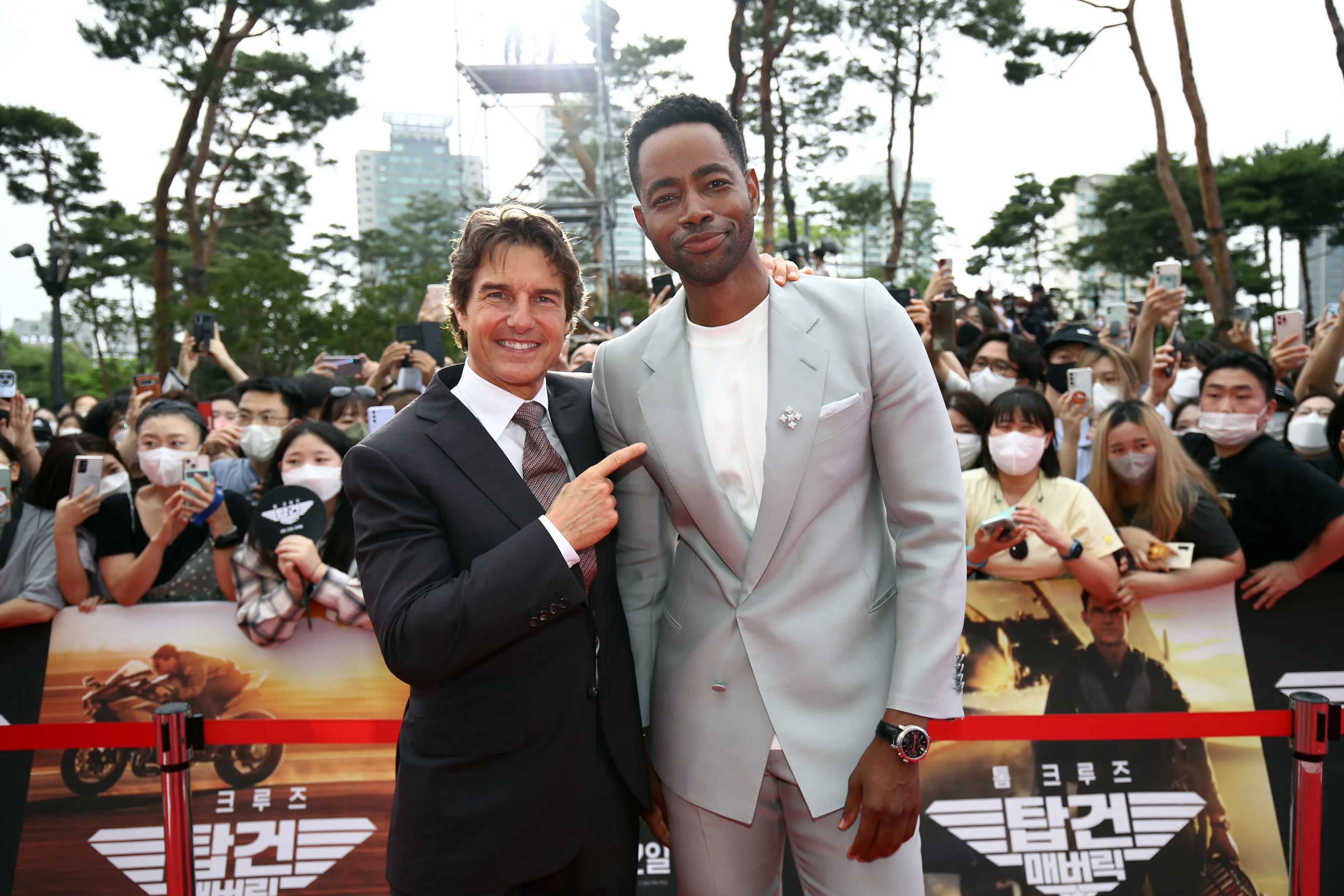 Jay Ellis and Tom Cruise posing together at an event