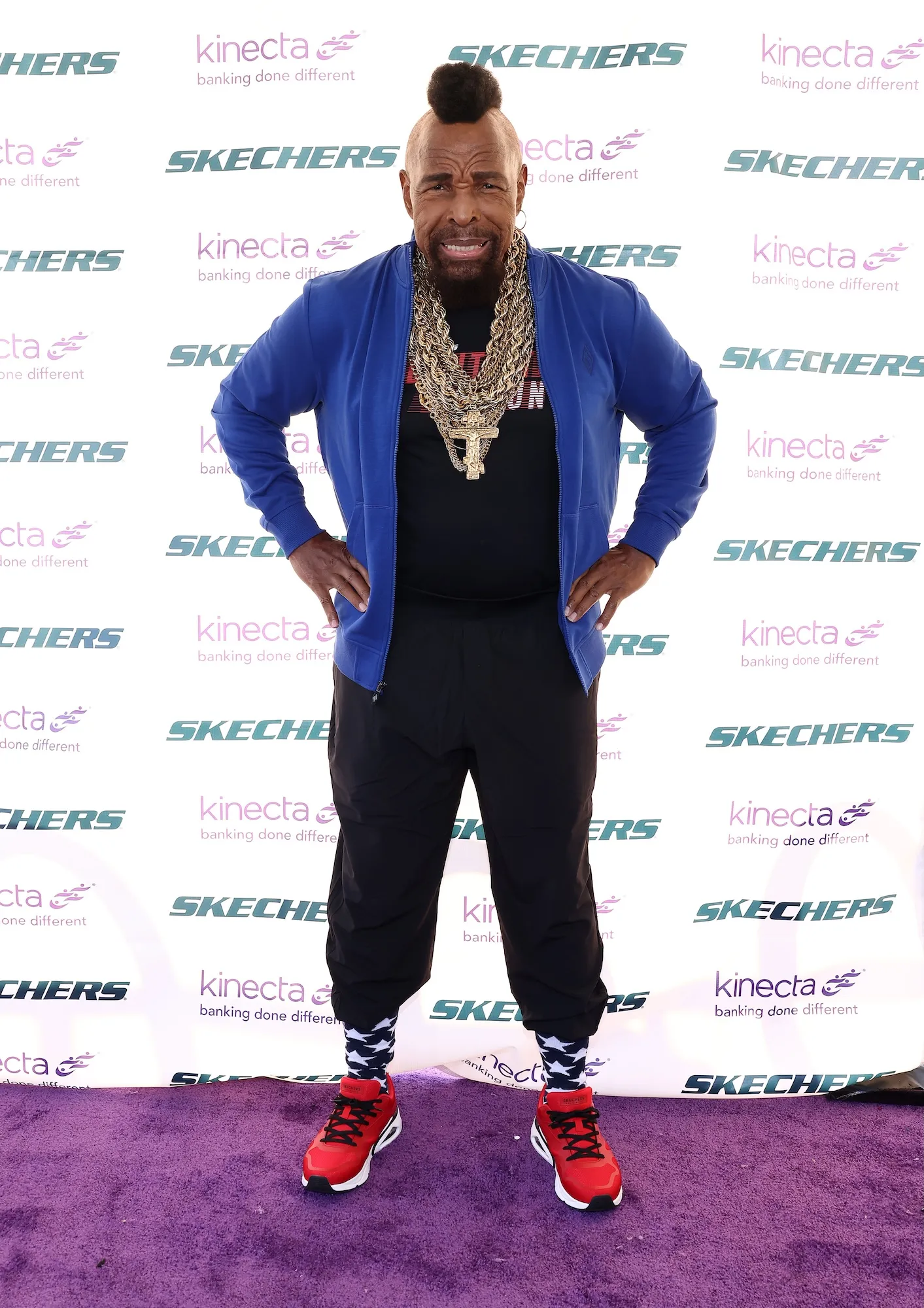Mr. T wearing his signature gold chains and mohawk at a public event