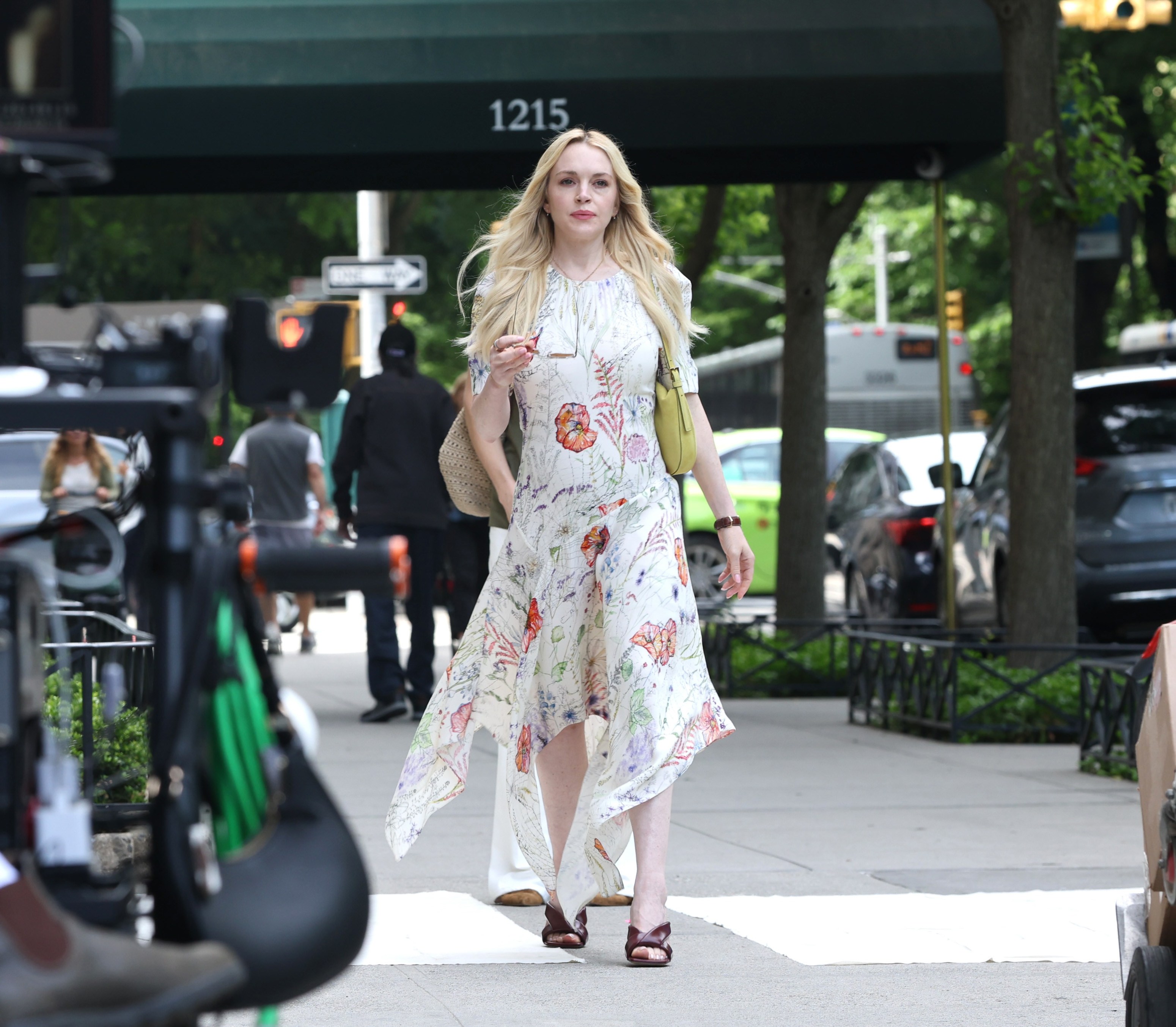 Lindsay Lohan posing in a sleek white satin maxi dress on a boat