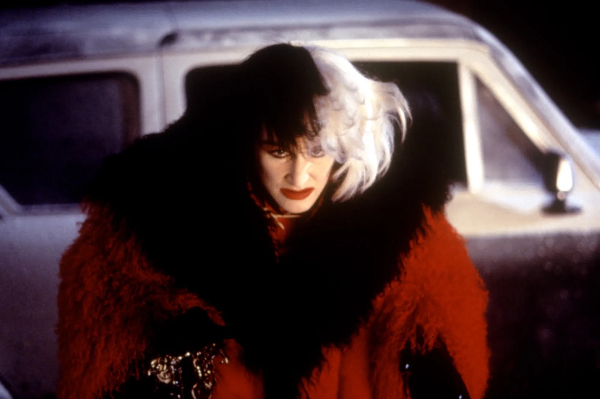 Glenn Close dressed in costume as Cruella de Vil on stage at D23