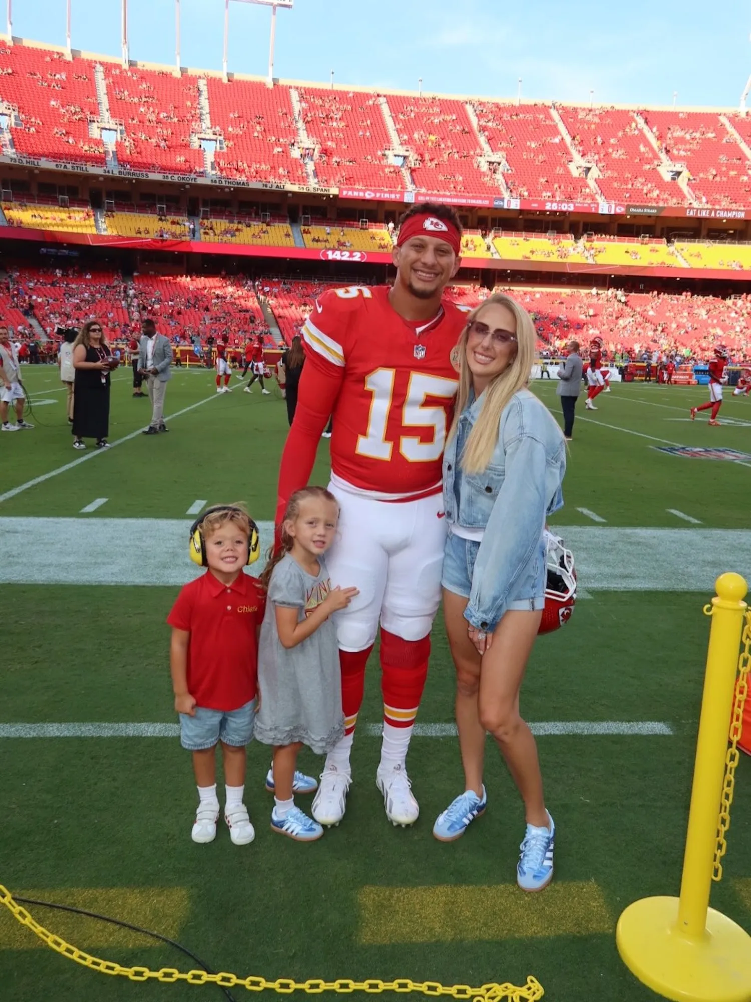 Brittany Mahomes wearing a double denim outfit at a Kansas City Chiefs game